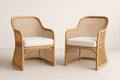 Pair of synthetic rattan armchairs with beige cushions